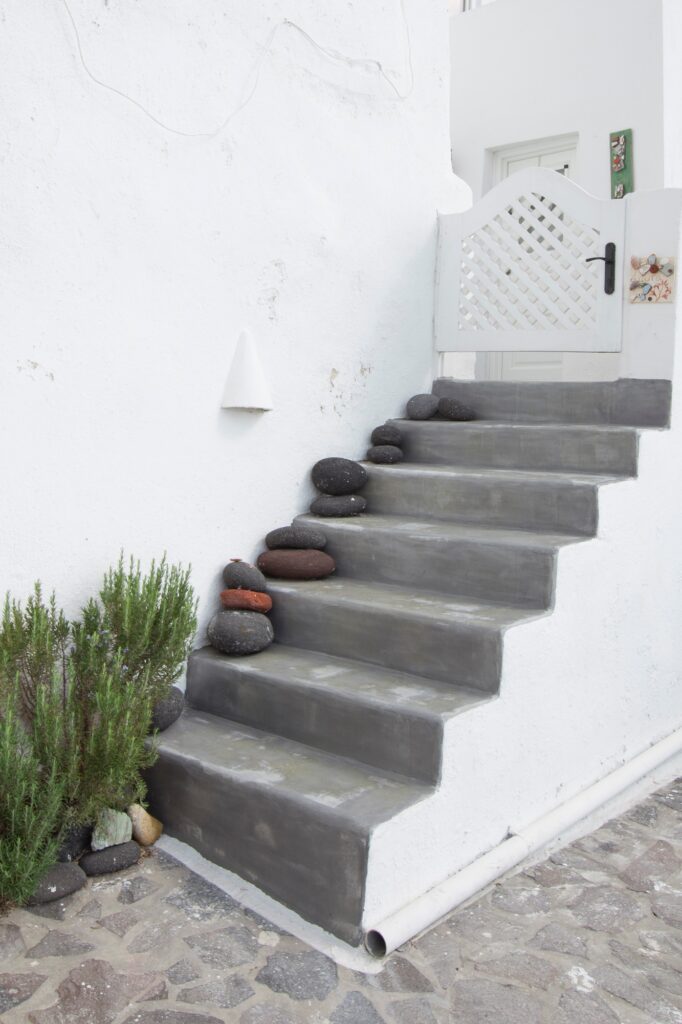 Patio stairs to a white home in santorini